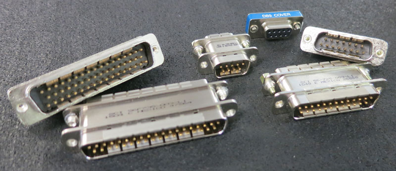 A group of filtered D-subminiature connectors in DB9, DB15 and DB25 shells of various pin counts, each with feedthrough capacitors built into the connector body