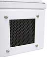 A honeycomb waveguide vent panel set into the wall of a white test enclosure, its hexagonal cells visible through the mounting frame