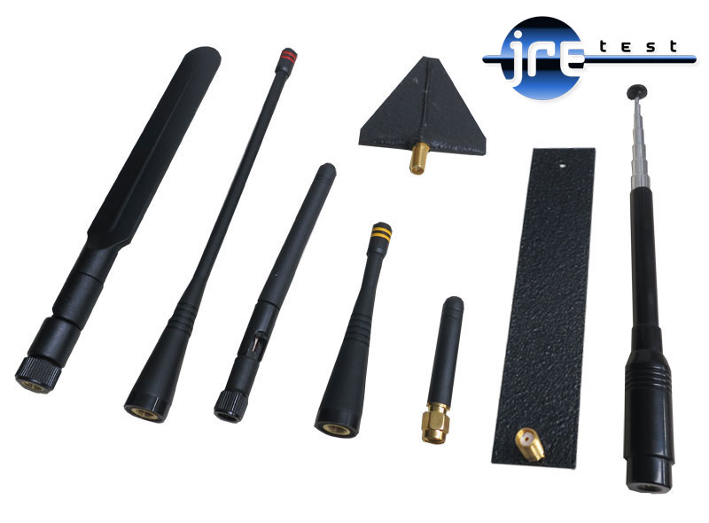 Seven test antennas from JRE Test: quarter-wave whips of several lengths, a telescoping whip, a flat patch element and a broadband cone, all SMA-terminated